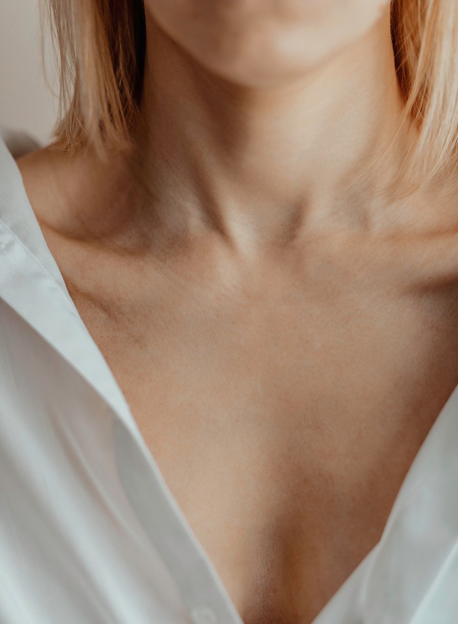 Close-up of a Young Woman's Neck and Collarbone. Lines on the Neck. Wrinkles, Age-Related Changes, Rings of Venus, Goosebumps.